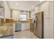 Updated kitchen showcasing white cabinets, granite countertops, and stainless steel appliances at 2332 Canalbluff Pl # 298, Sarasota, FL 34231