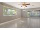 Bright, open-concept living room featuring tile floors, modern lighting, and large windows at 2332 Canalbluff Pl # 298, Sarasota, FL 34231