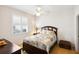 Cozy bedroom with a ceiling fan, a large window, and a comfortable bed at 2439 Sonoma W Dr, Nokomis, FL 34275