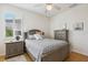 This bedroom features a window with plantation shutters and hardwood floors at 2439 Sonoma W Dr, Nokomis, FL 34275