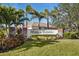Elegant Mission Estates entrance featuring lush landscaping and stately brick accents in this desirable community at 2439 Sonoma W Dr, Nokomis, FL 34275
