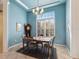 Elegant dining room with large windows, and a stylish chandelier perfect for Gathering meals at 2439 Sonoma W Dr, Nokomis, FL 34275