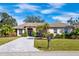 Charming single-story home featuring a meticulously landscaped front yard and beautiful brick driveway at 2439 Sonoma W Dr, Nokomis, FL 34275