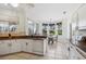 Bright kitchen with white cabinets, granite countertops, and a cozy breakfast nook with backyard views at 2439 Sonoma W Dr, Nokomis, FL 34275