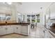 Bright kitchen featuring white cabinetry, breakfast nook with bay window, and tile flooring at 2439 Sonoma W Dr, Nokomis, FL 34275