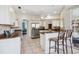 Spacious kitchen featuring granite countertops, stainless steel appliances, and breakfast bar at 2439 Sonoma W Dr, Nokomis, FL 34275