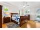 Bright main bedroom with tray ceiling, hardwood floors, and ensuite bathroom at 2439 Sonoma W Dr, Nokomis, FL 34275