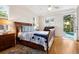 Bright main bedroom with hardwood floors, ensuite bathroom, and access to the pool at 2439 Sonoma W Dr, Nokomis, FL 34275