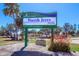 North Jetty Park sign in Sarasota County with lush surroundings and a glimpse of the pavilion at 2439 Sonoma W Dr, Nokomis, FL 34275