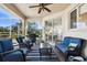 Relaxing covered patio includes furniture, outdoor grill, ceiling fan, and views of the outdoors at 2439 Sonoma W Dr, Nokomis, FL 34275