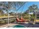 The screened-in pool offers a private oasis with serene views of the adjacent pond and natural landscape at 2439 Sonoma W Dr, Nokomis, FL 34275