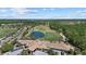 This aerial shows a golf course, club house, ponds, lush landscaping, and beautiful residential area in a vibrant community at 259 Golden Harbour Trl, Bradenton, FL 34212