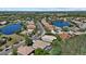 An aerial view highlights a beautiful residential area with tree-lined streets, picturesque lakes, and well-maintained homes at 259 Golden Harbour Trl, Bradenton, FL 34212