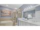 Bathroom with soaking tub, glass-enclosed shower, double sinks, and an illuminated mirror at 259 Golden Harbour Trl, Bradenton, FL 34212