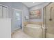 Bathroom featuring a soaking tub, tiled shower, and neutral finishes at 259 Golden Harbour Trl, Bradenton, FL 34212