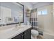 Bathroom featuring a vanity with dark cabinets, shower-tub combo, and a large framed mirror at 259 Golden Harbour Trl, Bradenton, FL 34212