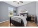 Bedroom with dark furniture, light walls, hardwood floors, and a window to the outside at 259 Golden Harbour Trl, Bradenton, FL 34212