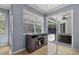 Bright dining room with view of the screened pool and patio through large glass doors at 259 Golden Harbour Trl, Bradenton, FL 34212