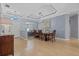 Open concept dining area featuring modern lighting, wood floors, and view to front entry at 259 Golden Harbour Trl, Bradenton, FL 34212