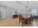 Bright dining room with wood floors, modern lighting and access to entry and living areas at 259 Golden Harbour Trl, Bradenton, FL 34212