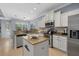 Well-lit kitchen features stainless steel appliances and island with granite countertops at 259 Golden Harbour Trl, Bradenton, FL 34212