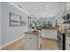 Bright kitchen with granite countertops, an island, and stainless steel appliances at 259 Golden Harbour Trl, Bradenton, FL 34212