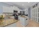 Well-lit kitchen with granite countertops, stainless appliances, and island at 259 Golden Harbour Trl, Bradenton, FL 34212