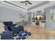 Living room featuring tray ceiling, recessed lights, a large couch, and built-in shelves at 259 Golden Harbour Trl, Bradenton, FL 34212