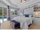 Spacious main bedroom with light walls, tray ceiling, built-in shelving and direct access to the pool area at 259 Golden Harbour Trl, Bradenton, FL 34212