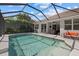 A stunning pool with a screened lanai and seating area, perfect for outdoor entertaining and enjoying the Florida lifestyle at 259 Golden Harbour Trl, Bradenton, FL 34212