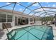 A sparkling pool with a screened enclosure offers relaxation and entertainment space, connecting indoor and outdoor living seamlessly at 259 Golden Harbour Trl, Bradenton, FL 34212