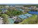 Aerial view of the tennis and basketball courts in this community featuring ponds, lush landscaping, and walking trails at 259 Golden Harbour Trl, Bradenton, FL 34212