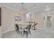 Dining area featuring modern light fixture, table with six chairs, and accent wall at 282 Sapphire Lake Drive Dr # 201, Bradenton, FL 34209