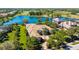 Aerial view of a beautiful property surrounded by lush landscaping, lake, and golf course at 3153 Founders Club Dr, Sarasota, FL 34240