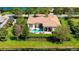 Beautiful backyard with a pool, outdoor seating, lush landscaping, and a serene waterfront view at 3153 Founders Club Dr, Sarasota, FL 34240