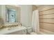 Well-lit bathroom features a shower/tub with tiled accents, sleek vanity, and modern fixtures at 3153 Founders Club Dr, Sarasota, FL 34240