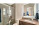 Modern bathroom boasts a glass-enclosed shower, vanity with storage, and illuminated mirror at 3153 Founders Club Dr, Sarasota, FL 34240