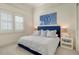 Bright bedroom with a blue bedframe, crisp white linens, and a large window providing natural light at 3153 Founders Club Dr, Sarasota, FL 34240