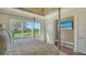 Bedroom featuring a four-poster bed, scenic outdoor views, and a mounted television at 3153 Founders Club Dr, Sarasota, FL 34240