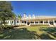 Inviting clubhouse featuring a long front porch, columns, and well-manicured landscaping at 3153 Founders Club Dr, Sarasota, FL 34240