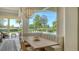Bright dining area with banquette seating and serene views of the pool and waterfront at 3153 Founders Club Dr, Sarasota, FL 34240