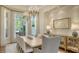 Beautiful dining room featuring modern chandelier, table for eight and neutral decor at 3153 Founders Club Dr, Sarasota, FL 34240