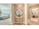 Inviting foyer featuring round mirror and a glimpse into the bedroom with marble floors at 3153 Founders Club Dr, Sarasota, FL 34240