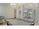 Spacious game room with pool table, offering a view of the outdoor pool and seating area at 3153 Founders Club Dr, Sarasota, FL 34240
