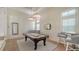 Bright game room features a pool table, modern lighting, and stylish decor for entertainment and relaxation at 3153 Founders Club Dr, Sarasota, FL 34240
