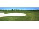 Scenic view of a well-manicured golf course with lush green fairways and a pristine white sand bunker at 3153 Founders Club Dr, Sarasota, FL 34240