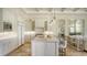 Open-concept kitchen with a large island, pendant lighting, and views into the adjacent living spaces at 3153 Founders Club Dr, Sarasota, FL 34240
