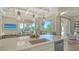 Gourmet kitchen island with bar seating, overlooking the dining area and the outdoor patio at 3153 Founders Club Dr, Sarasota, FL 34240