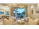 Bright and airy living room with views of the outdoor pool and entertainment area at 3153 Founders Club Dr, Sarasota, FL 34240