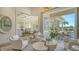 Bright living room with neutral furniture, open to the outdoor patio and a view of the pool at 3153 Founders Club Dr, Sarasota, FL 34240